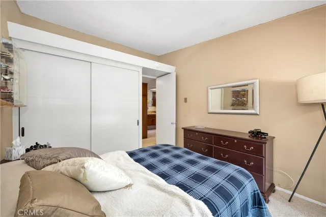 a bedroom with a bed and a dresser