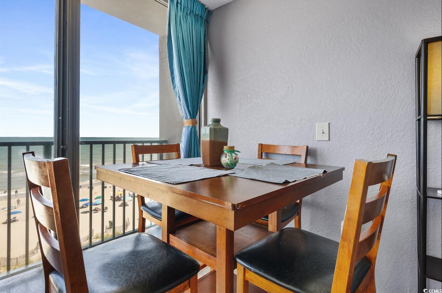 201 74th Avenue North, Unit 2527 Myrtle Beach, SC 29572 - Photo 14 of 18 Dining space with a textured wall and a water view