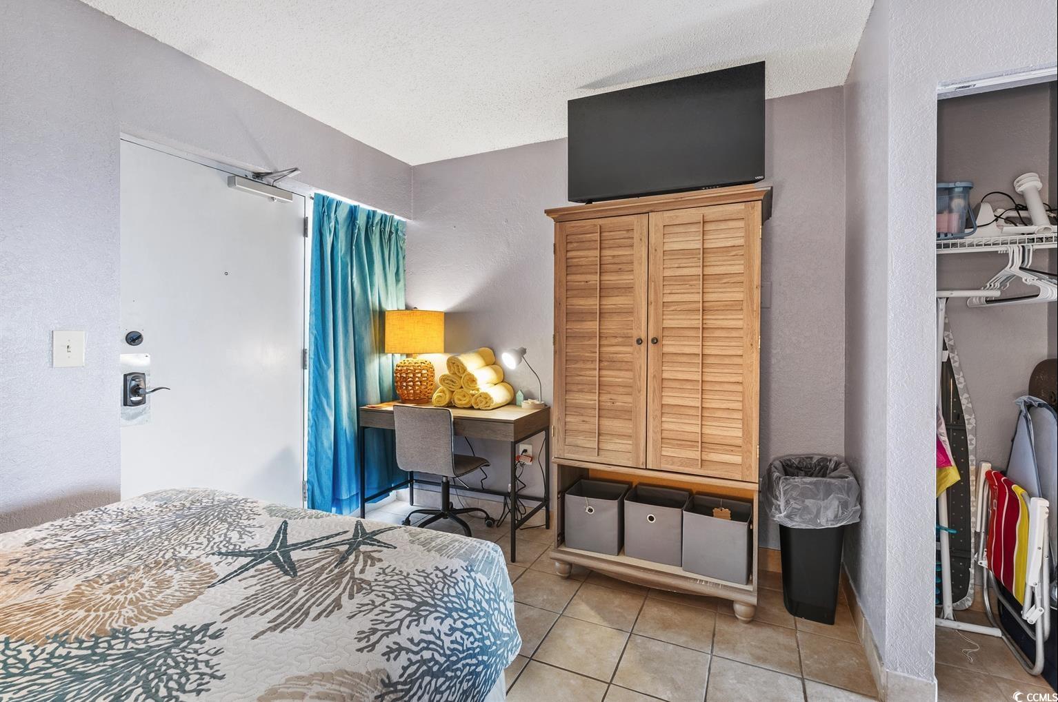 201 74th Avenue North, Unit 2527 Myrtle Beach, SC 29572 - Photo 3 of 18 Bedroom with tile patterned flooring and a textured wall
