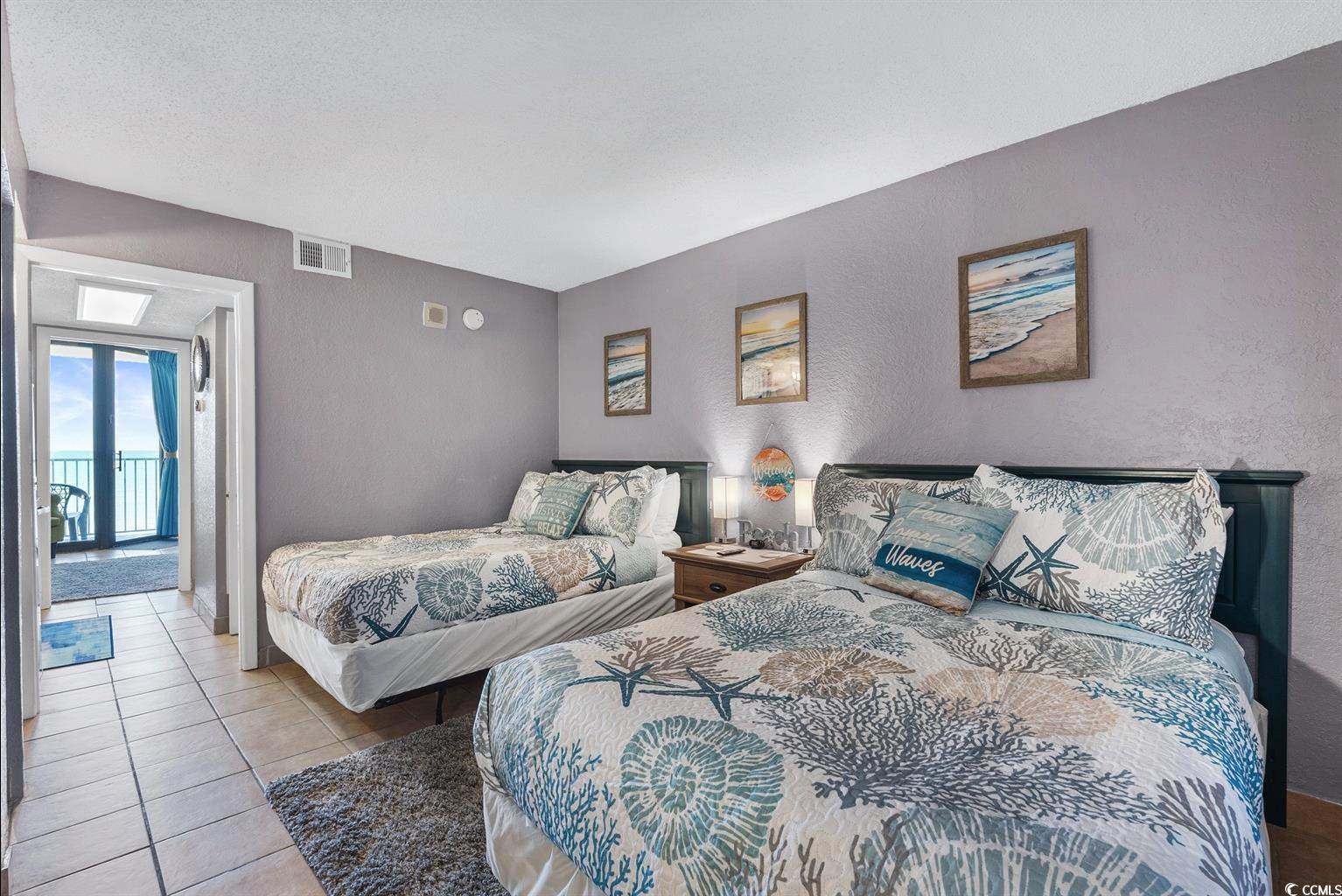 201 74th Avenue North, Unit 2527 Myrtle Beach, SC 29572 - Photo 4 of 18 Bedroom featuring a textured wall and tile patterned floors
