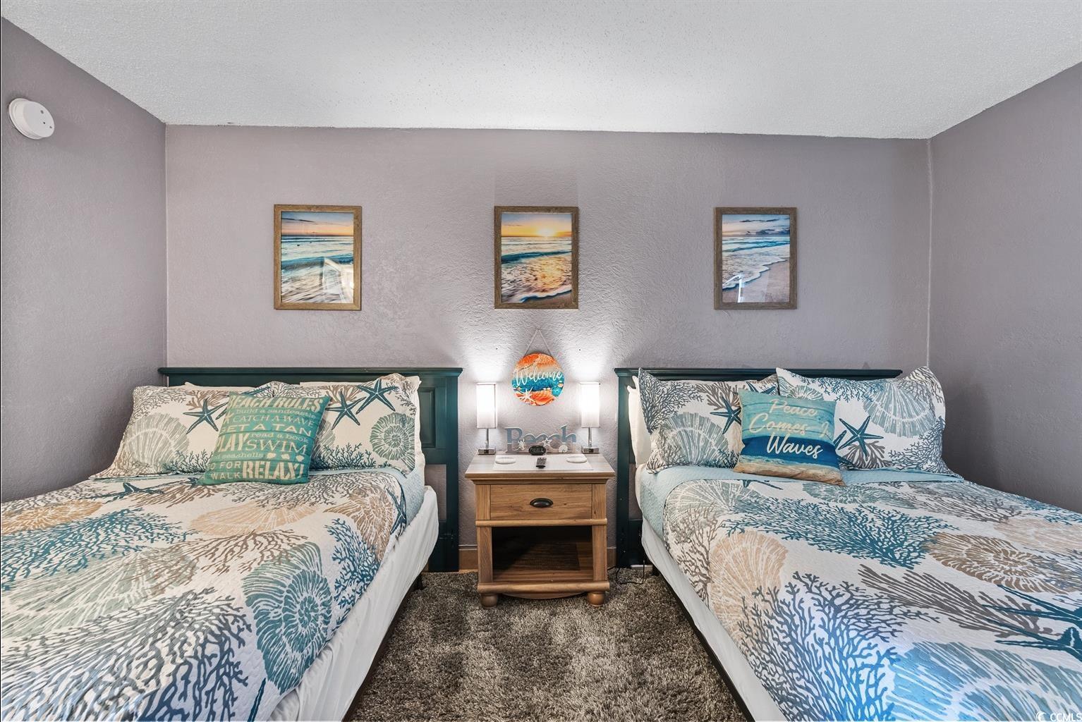 201 74th Avenue North, Unit 2527 Myrtle Beach, SC 29572 - Photo 5 of 18 Bedroom featuring dark carpet and a textured wall