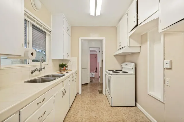 a kitchen with sink cabinets and refrigerator