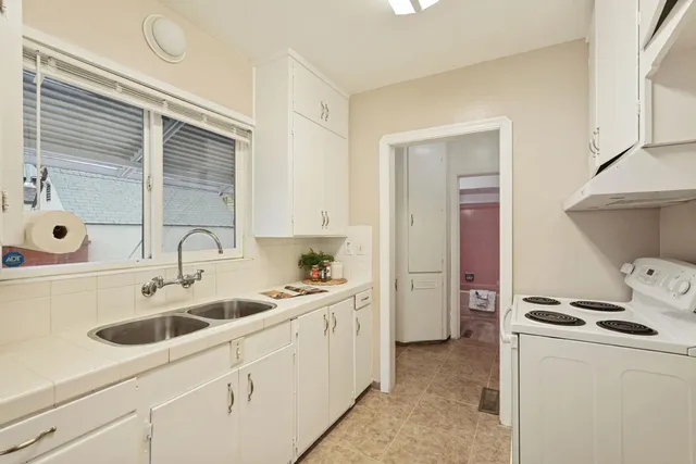 a kitchen with a sink cabinets and appliances