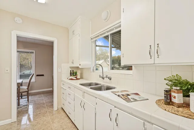 a kitchen with sink and cabinets