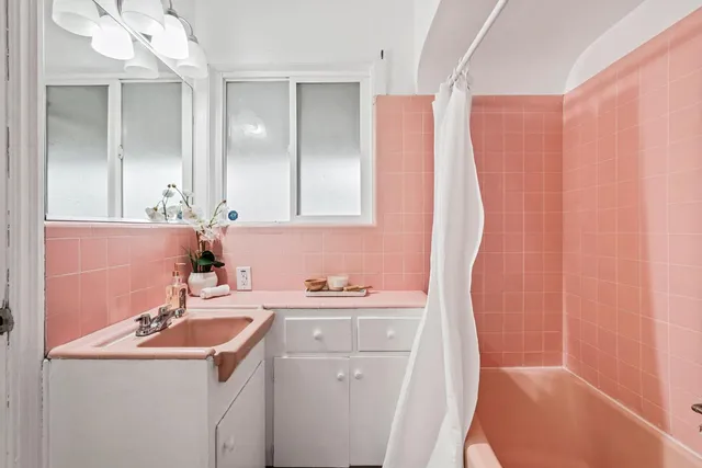 a bathroom with a sink a toilet a mirror and vanity