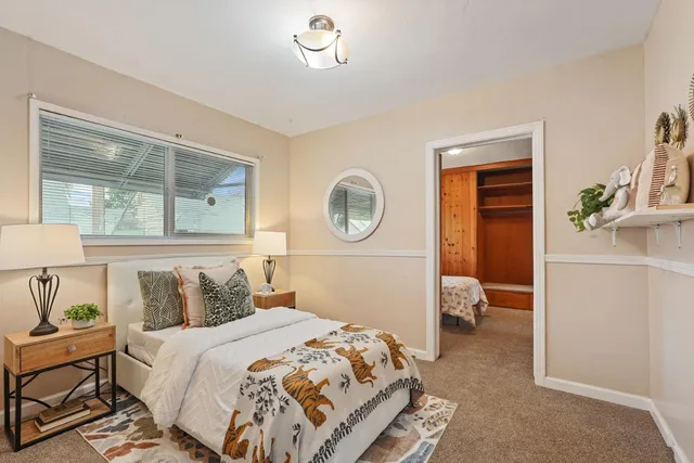 a bedroom with a bed and a window