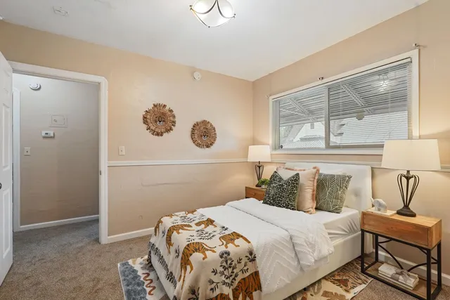 a bedroom with a bed and a window