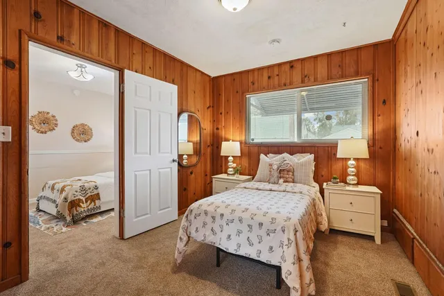 a bedroom with a bed and a mirror