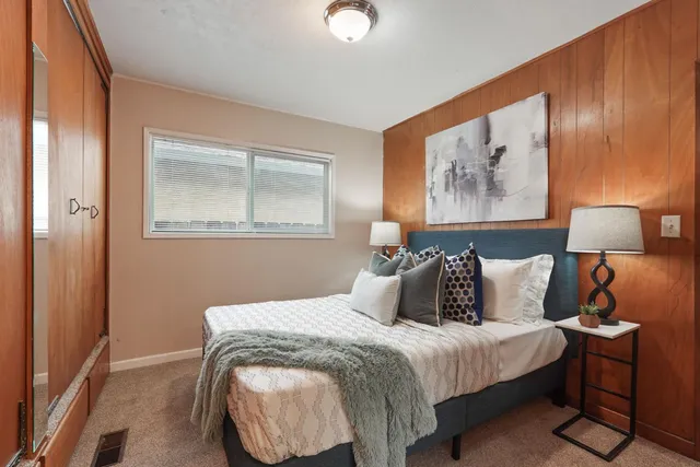 a bedroom with a bed and lamp