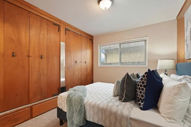 a bedroom with a bed and a window