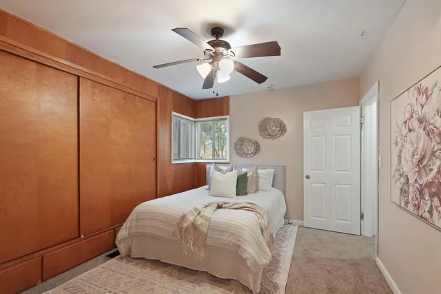 a bedroom with a bed and a chandelier