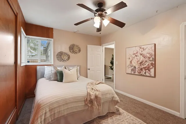 a bedroom with a large bed and a window