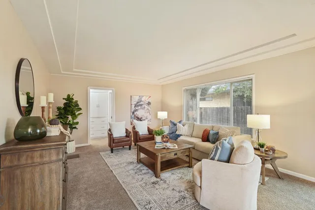 a living room with furniture and a table