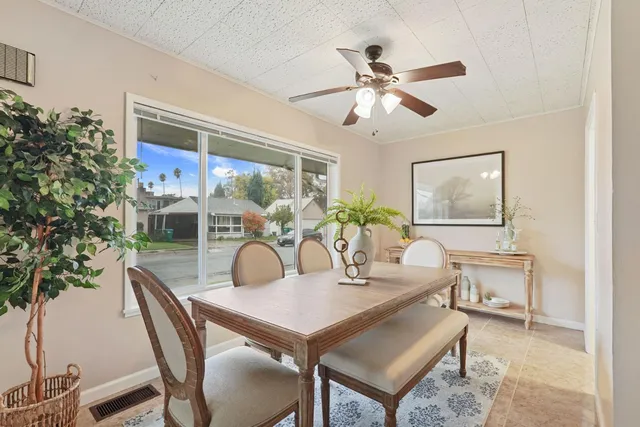 a dining room with furniture a window and a chandelier