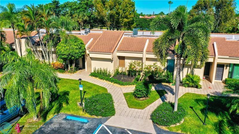 7495 La Paz Boulevard, Unit 105 Boca Raton, FL 33433 - Photo 1 of 29 an aerial view of a house with a yard and trees