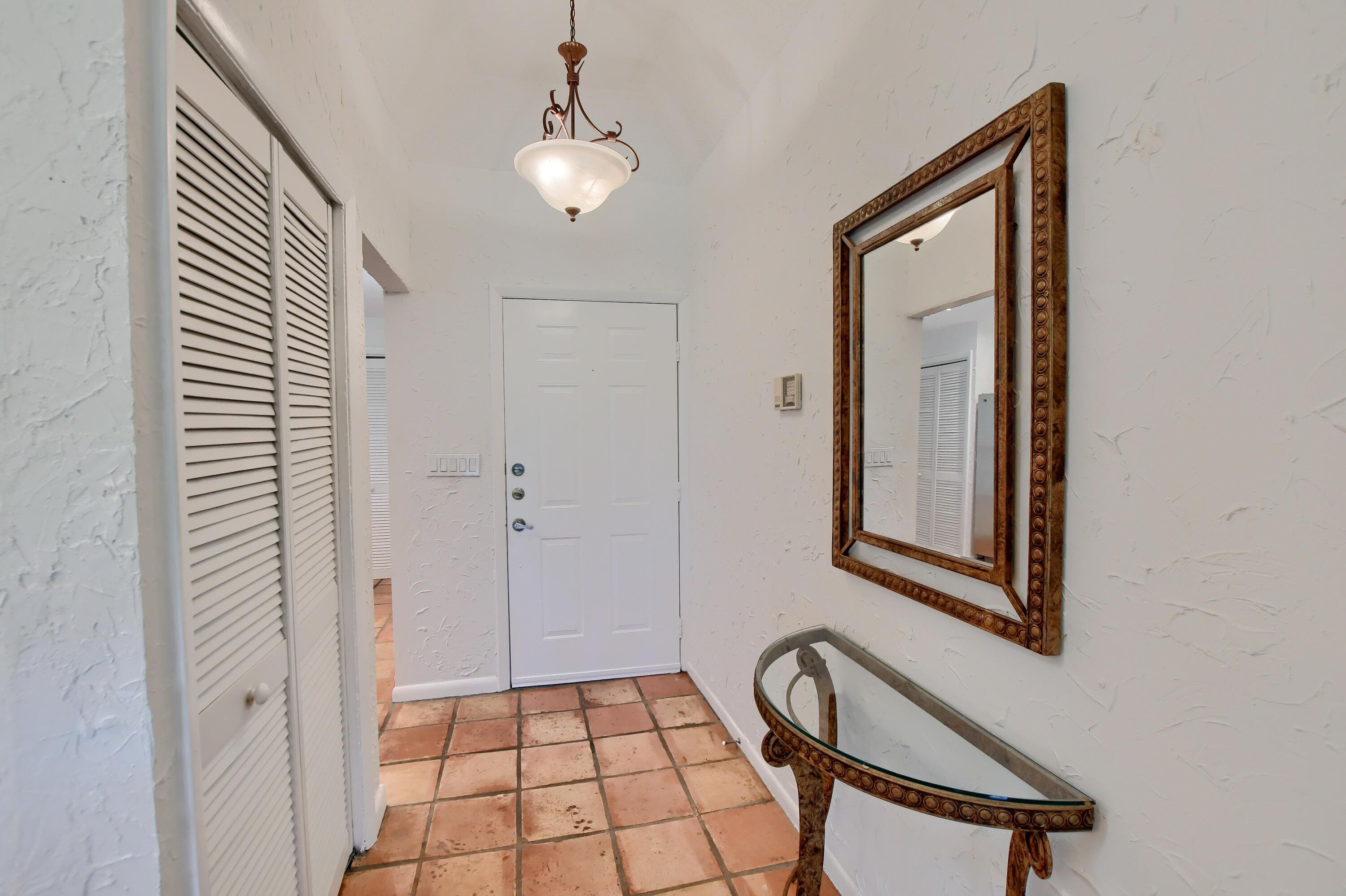 7495 La Paz Boulevard, Unit 105 Boca Raton, FL 33433 - Photo 2 of 29 a view of an entryway with wooden floor