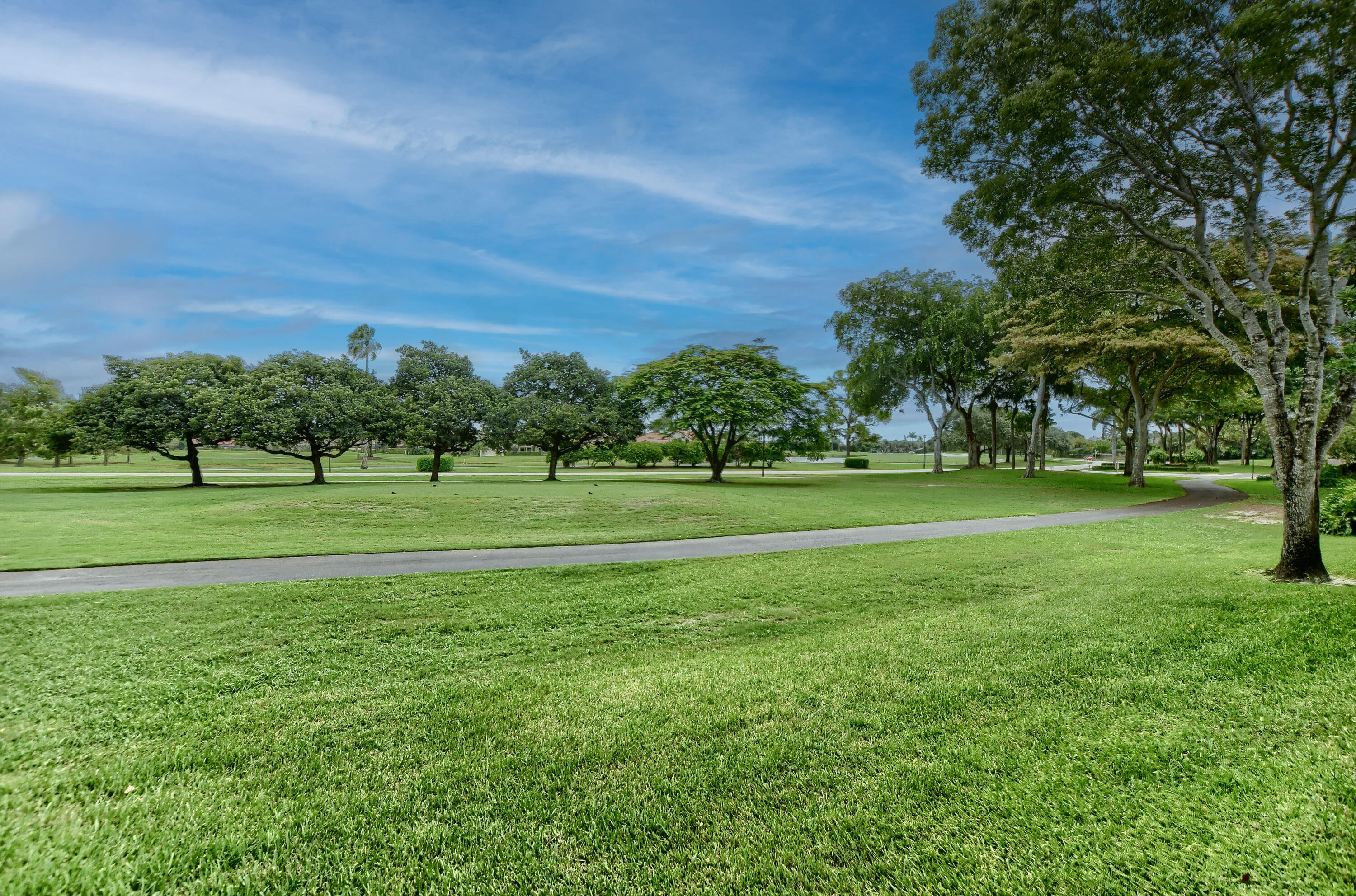 7495 La Paz Boulevard, Unit 105 Boca Raton, FL 33433 - Photo 26 of 29 a view of a park with trees and houses