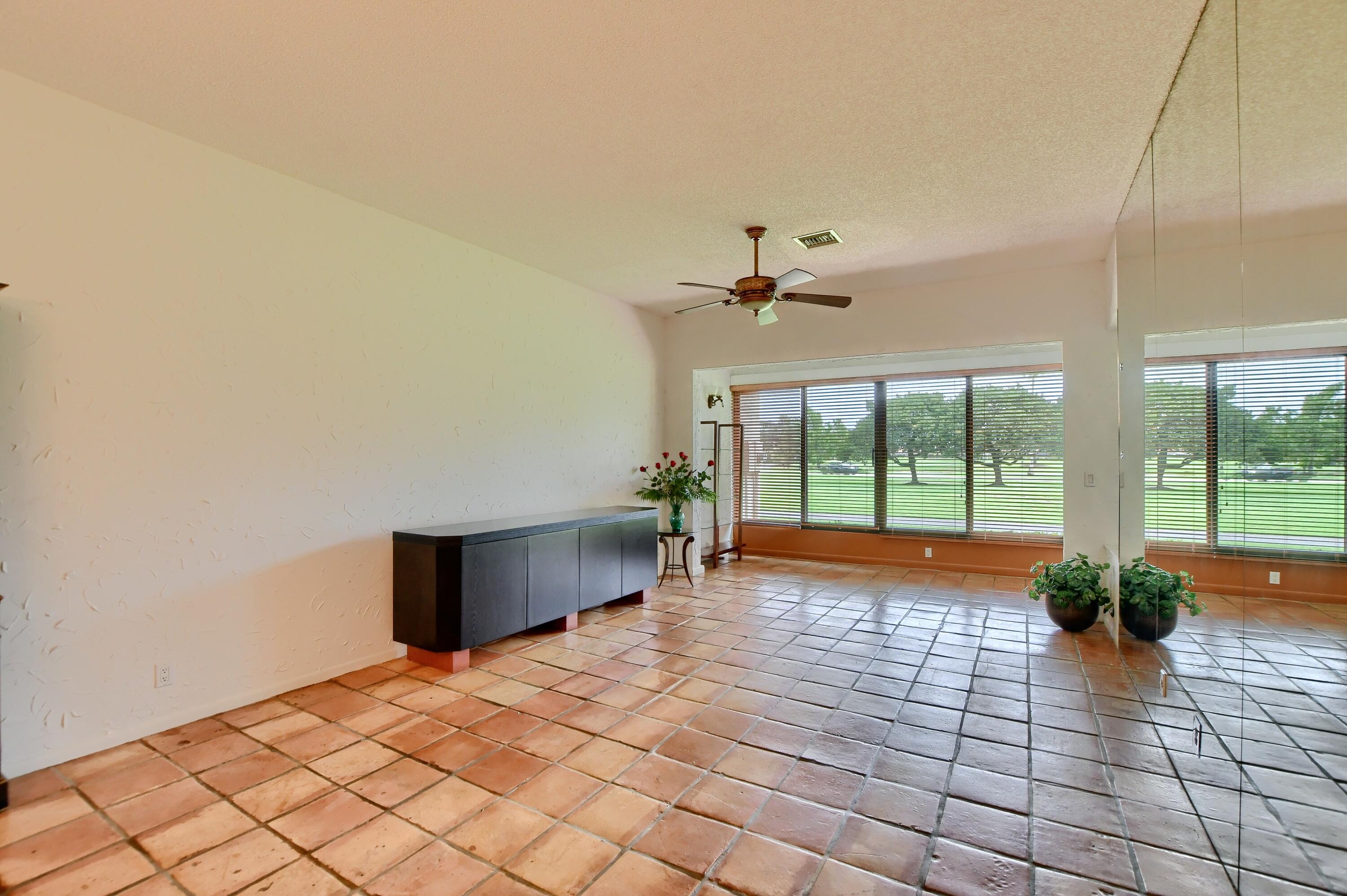 7495 La Paz Boulevard, Unit 105 Boca Raton, FL 33433 - Photo 5 of 29 a view of empty room with wooden floor and fan