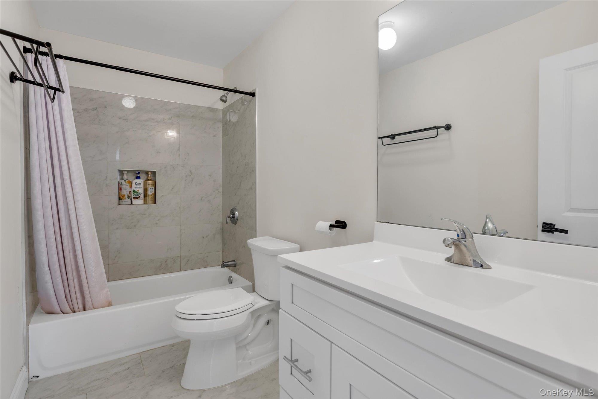 135 Elizabeth Way Ridge, NY 11961 - Photo 16 of 24 a bathroom with a sink toilet and shower