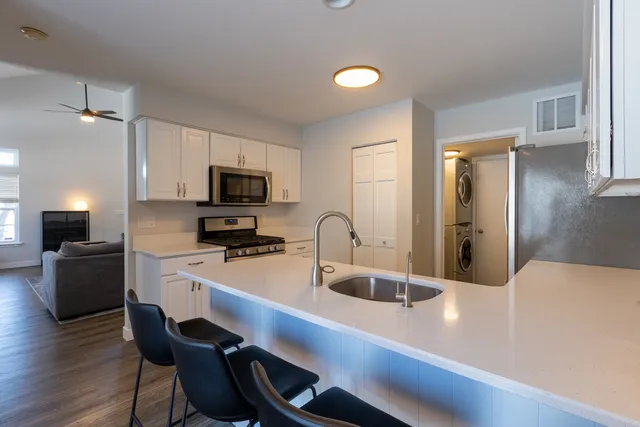 a kitchen with a sink cabinets and stainless steel appliances