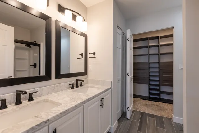 a bathroom with a granite countertop sink and a mirror