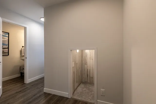 a view of hallway with wooden floor