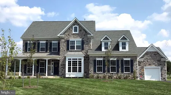 a kitchen with stainless steel appliances kitchen island granite countertop a dining table chairs and white cabinets