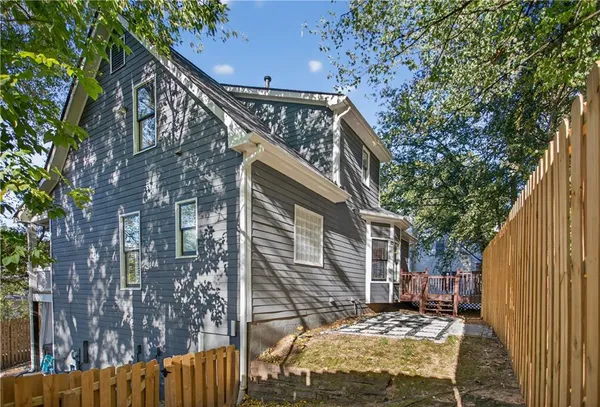 a brick house with trees in front of it