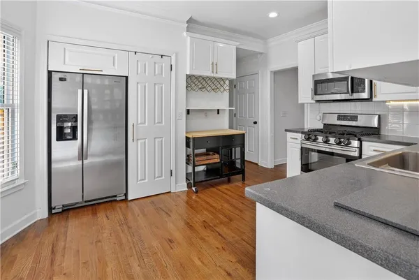 a spacious bedroom with a bed a couch and a flat screen tv