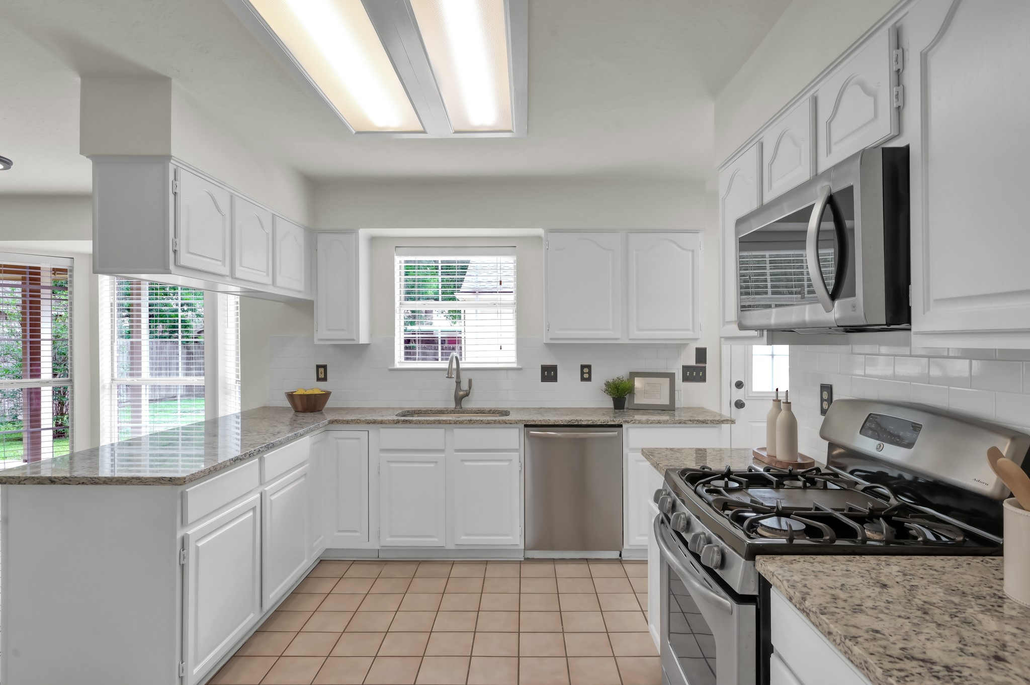 114 Regency Way Conroe, TX 77304 - Photo 15 of 48 Recently updated kitchen with stainless steel applicances and granite countertops open to the breakfast area and living room.