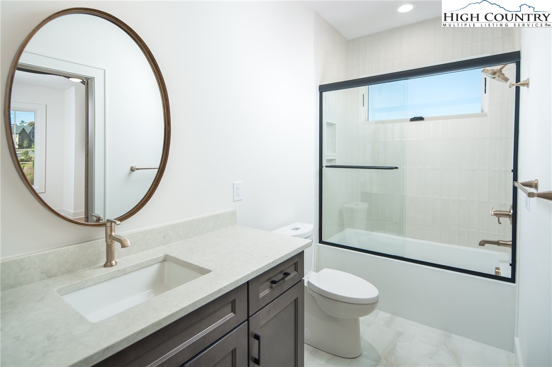 359 Calico Court Boone, NC 28607 - Photo 25 of 50 a bathroom with a sink a toilet and a mirror