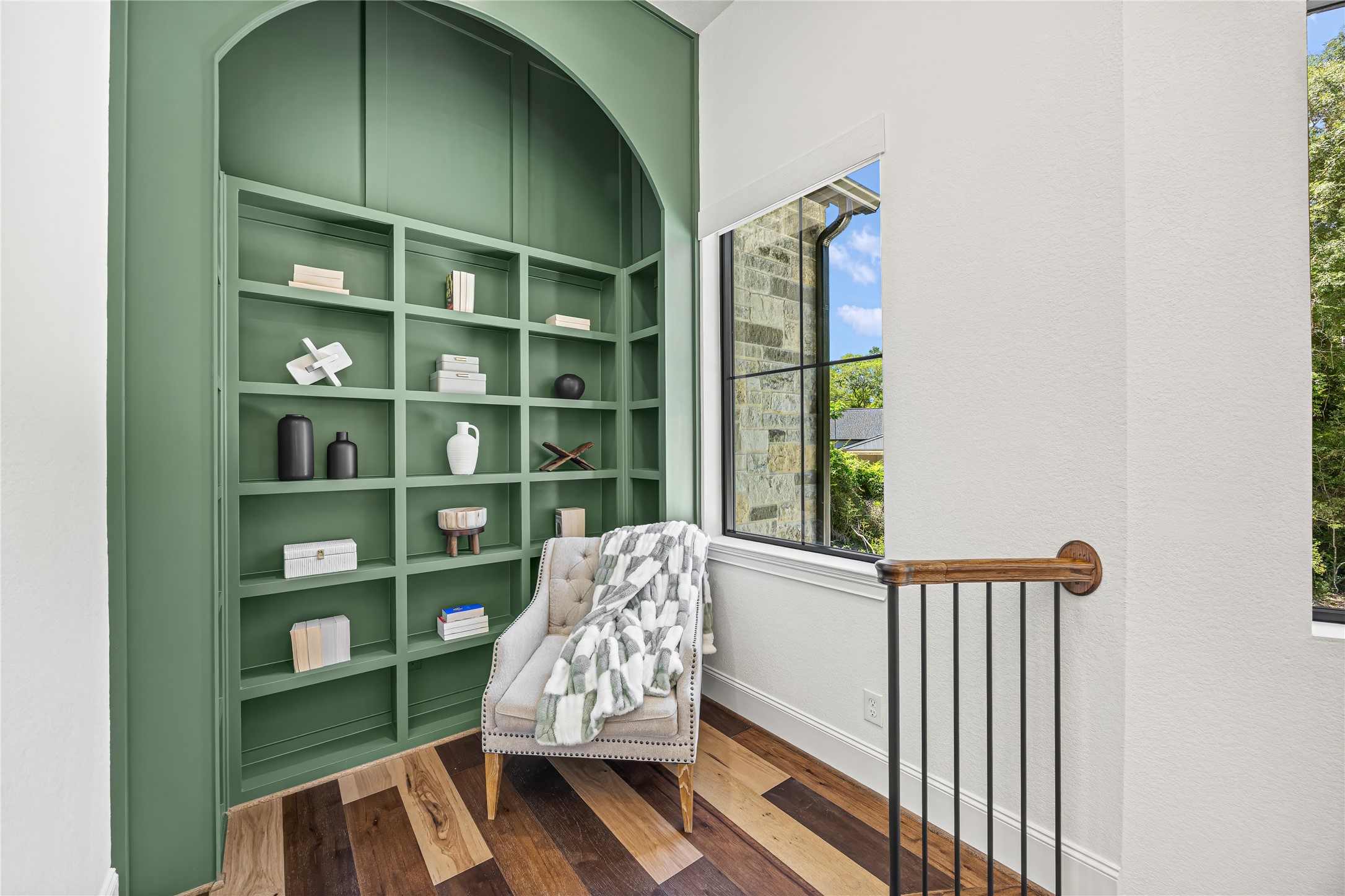19314 Chateau Ridge Court Tomball, TX 77377 - Photo 26 of 50 A beautifully styled nook at the top of the stairs, featuring a custom arched built-in and a cozy seating area bathed in natural light.