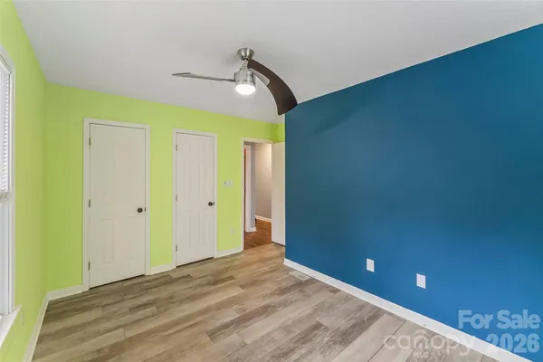 an empty room with windows and closet
