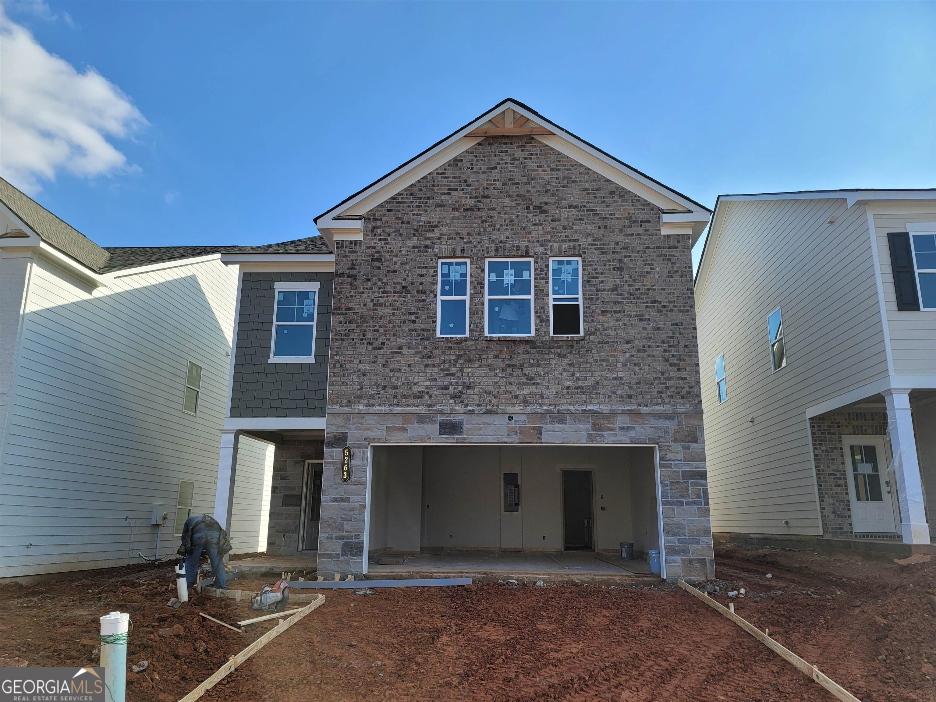 a front view of a house with garage