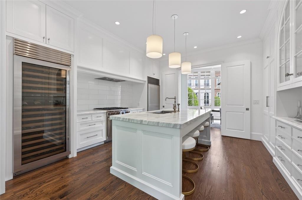 2288 Peachtree Road Northwest, Unit 4 Atlanta, GA 30309 - Photo 11 of 50 a kitchen with kitchen island white cabinets and stainless steel appliances