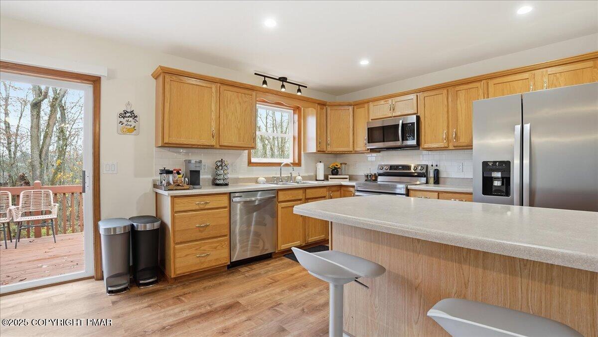 163 Long Woods Road Tobyhanna, PA 18466 - Photo 11 of 52 a kitchen with stainless steel appliances granite countertop a refrigerator a stove top oven a sink and dishwasher