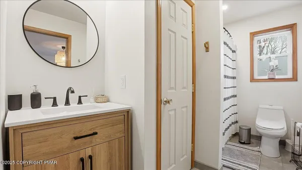 a bathroom with a sink a mirror a toilet and a mirror