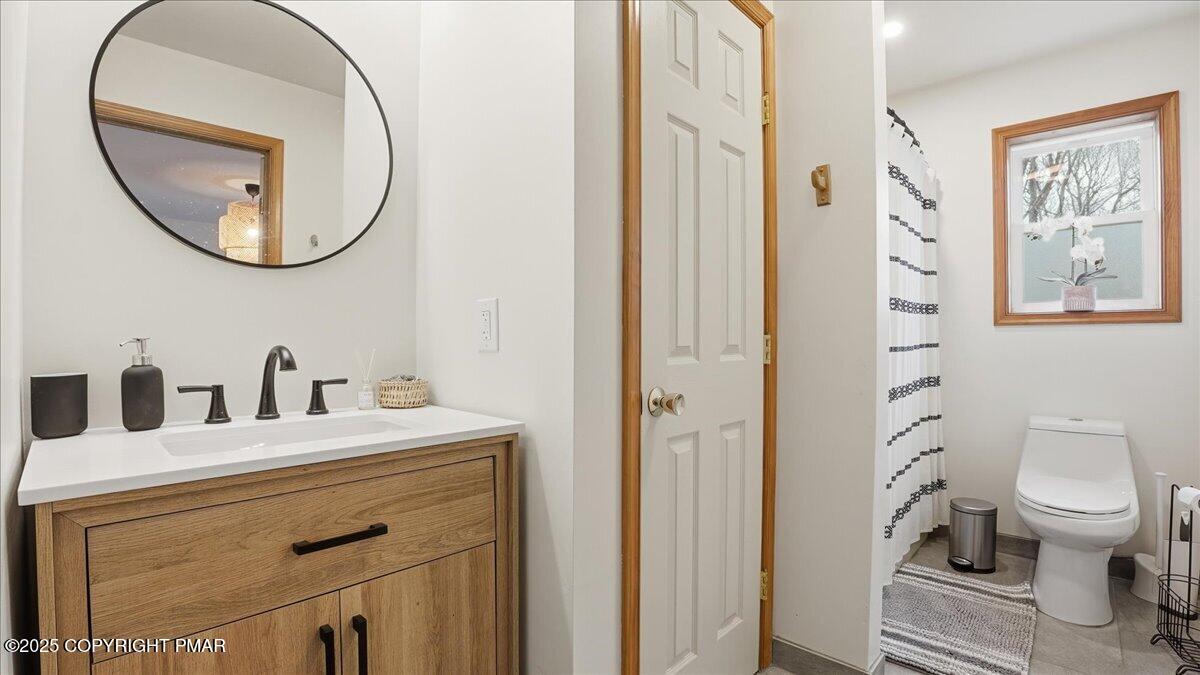 163 Long Woods Road Tobyhanna, PA 18466 - Photo 12 of 52 a bathroom with a sink a mirror a toilet and a mirror
