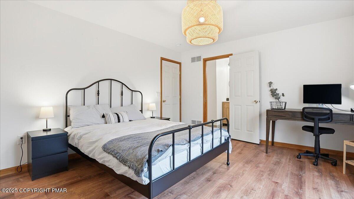 163 Long Woods Road Tobyhanna, PA 18466 - Photo 14 of 52 a bedroom with a bed and a table
