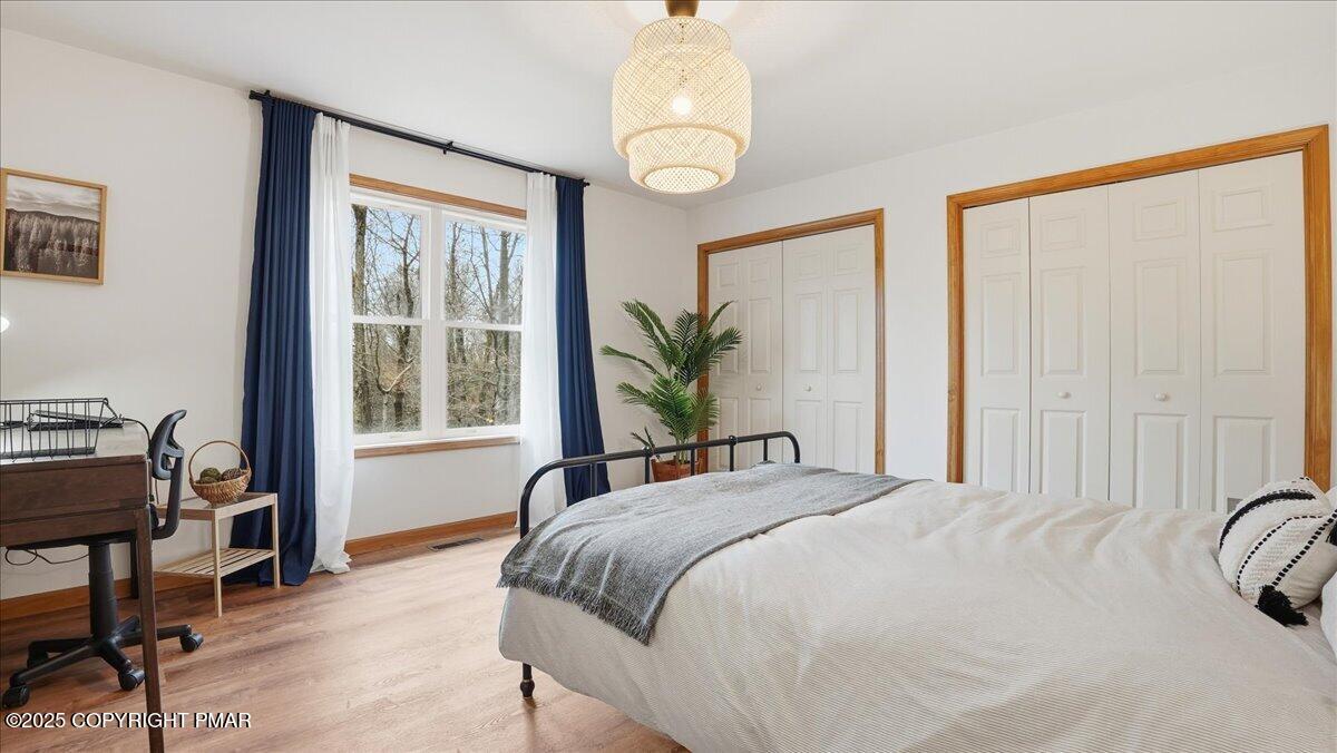 163 Long Woods Road Tobyhanna, PA 18466 - Photo 15 of 52 a bedroom with a bed and a table in it with chair