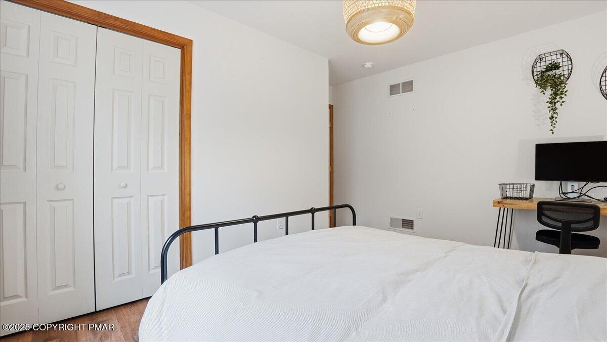 163 Long Woods Road Tobyhanna, PA 18466 - Photo 20 of 52 a bedroom with a bed and a tv in it