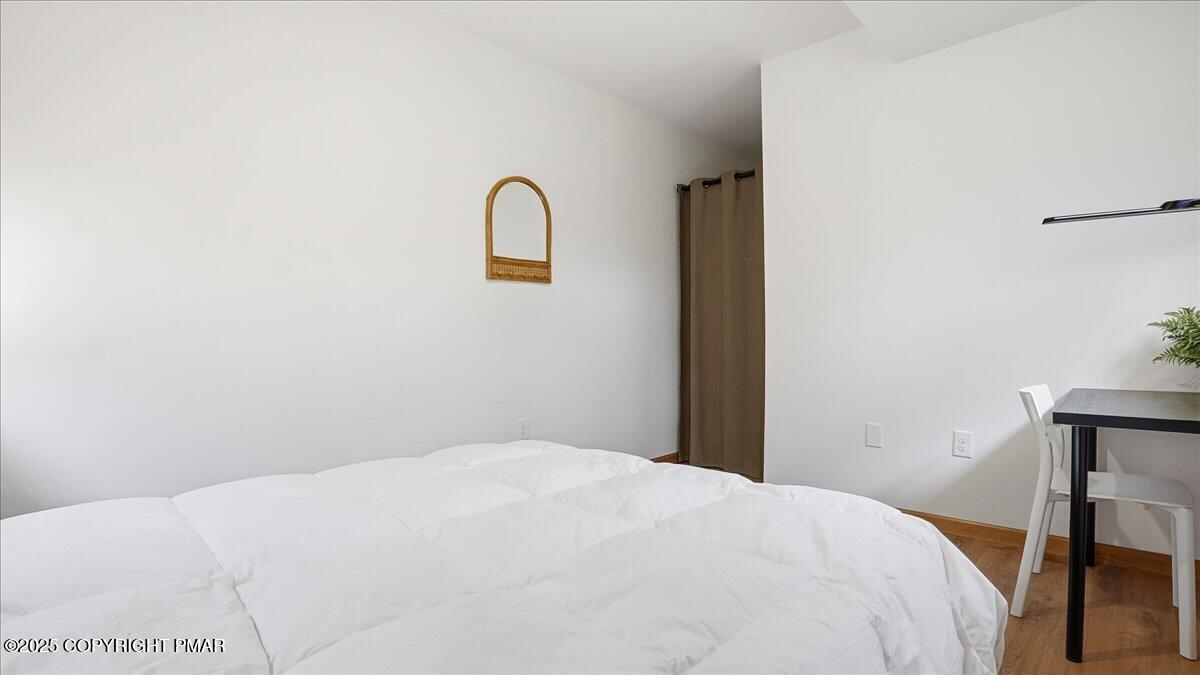163 Long Woods Road Tobyhanna, PA 18466 - Photo 34 of 52 a bedroom with a bed and a table