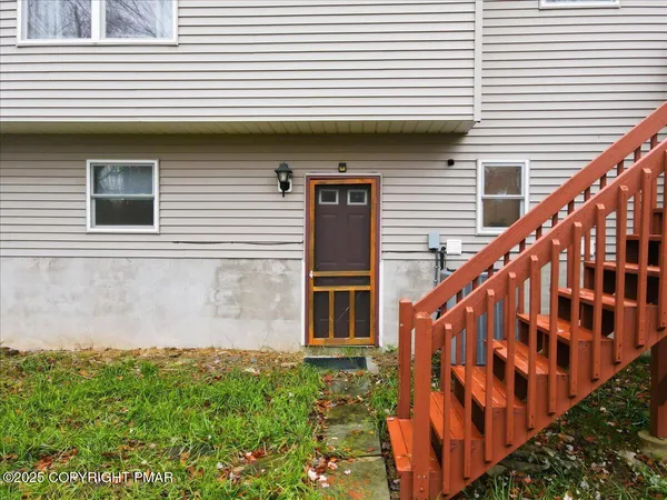 a view of a house with a wooden fence