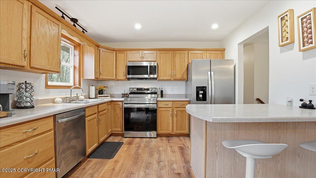 163 Long Woods Road Tobyhanna, PA 18466 - Photo 42 of 52 a kitchen with stainless steel appliances granite countertop a sink stove and refrigerator