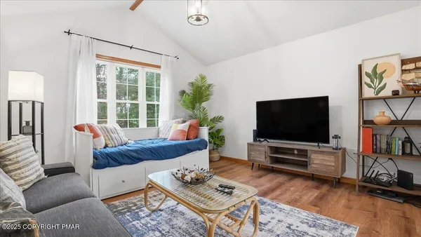 a living room with furniture and a flat screen tv