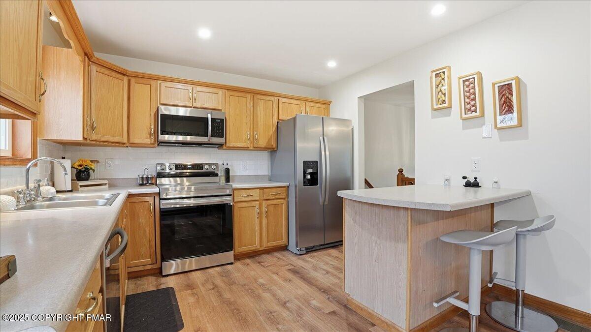 163 Long Woods Road Tobyhanna, PA 18466 - Photo 7 of 52 a kitchen with stainless steel appliances a stove refrigerator sink and microwave