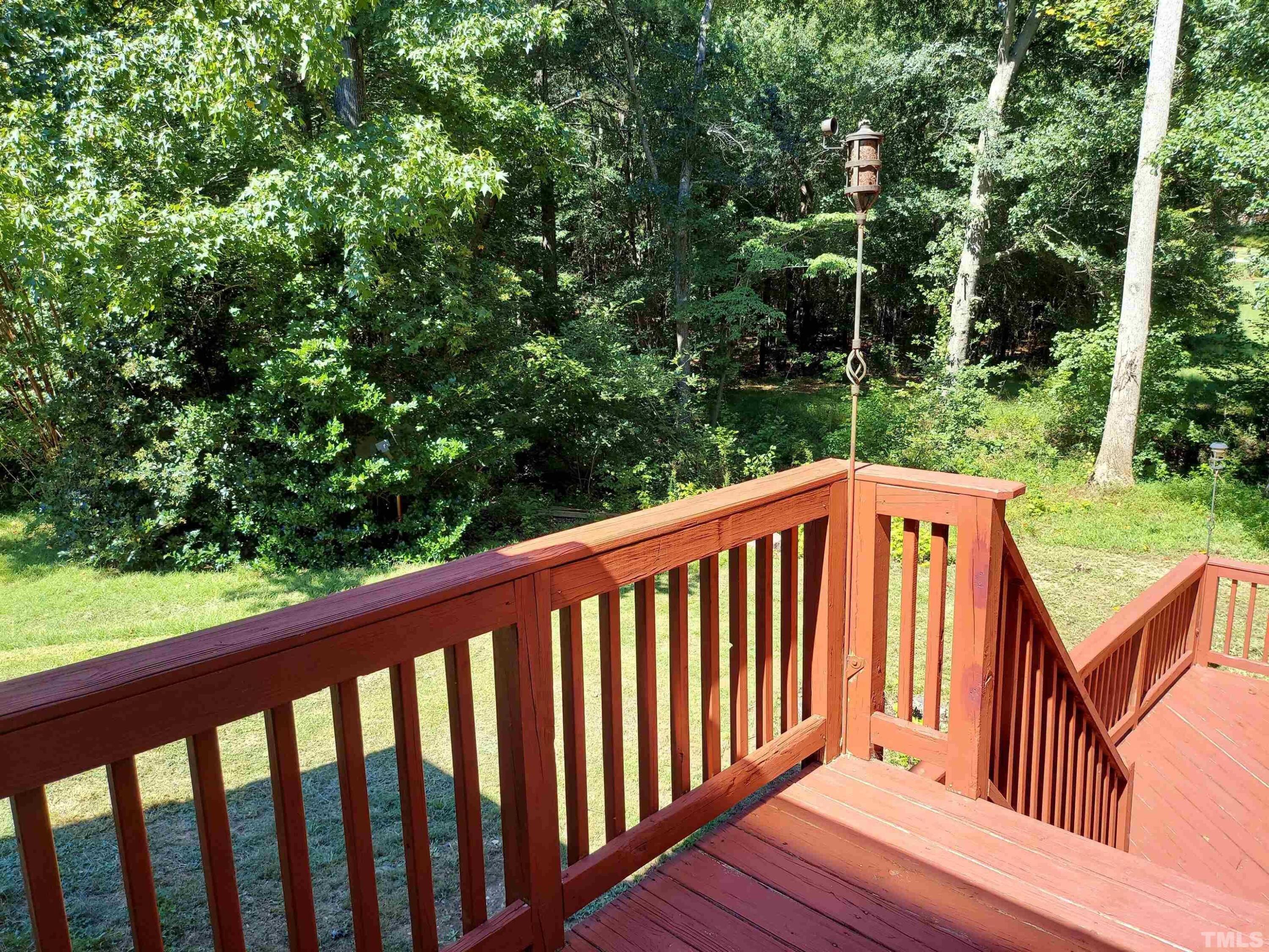 224 Crossfire Road Holly Springs, NC 27540 - Photo 39 of 43 a balcony with wooden floor and trees in the back