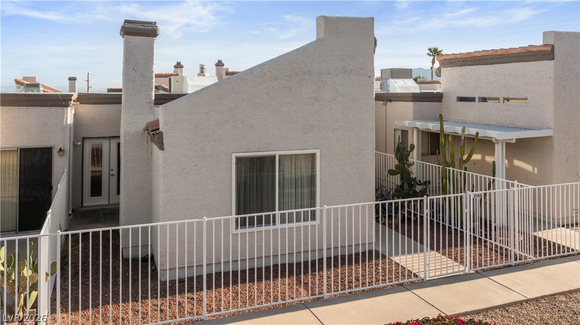 2146 High Dunes Lane Laughlin, NV 89029 - Photo 48 of 64 View of home's exterior with stucco siding and fence