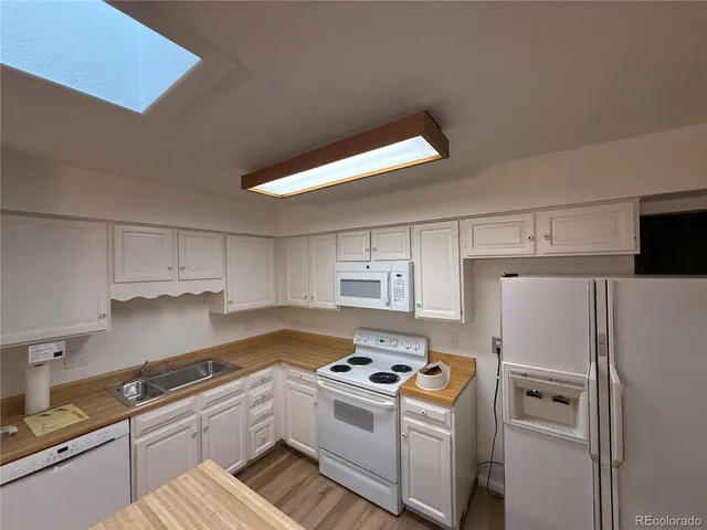 a kitchen with a stove a refrigerator and a sink