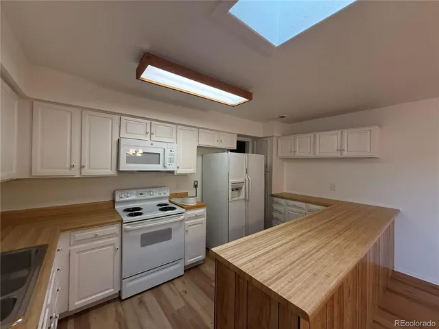 a kitchen with refrigerator and cabinets